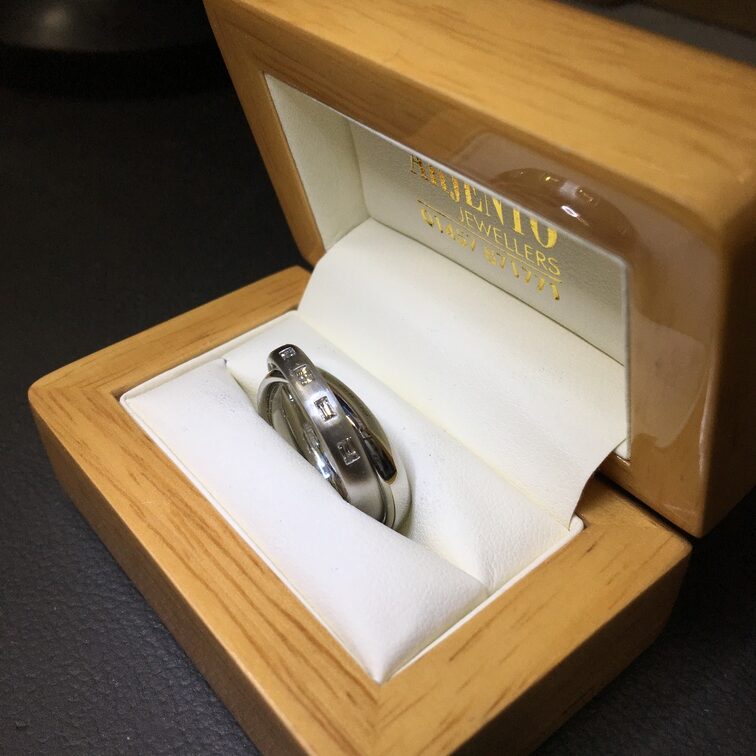 Platinum ring set with princess cut diamonds and square emerald stones